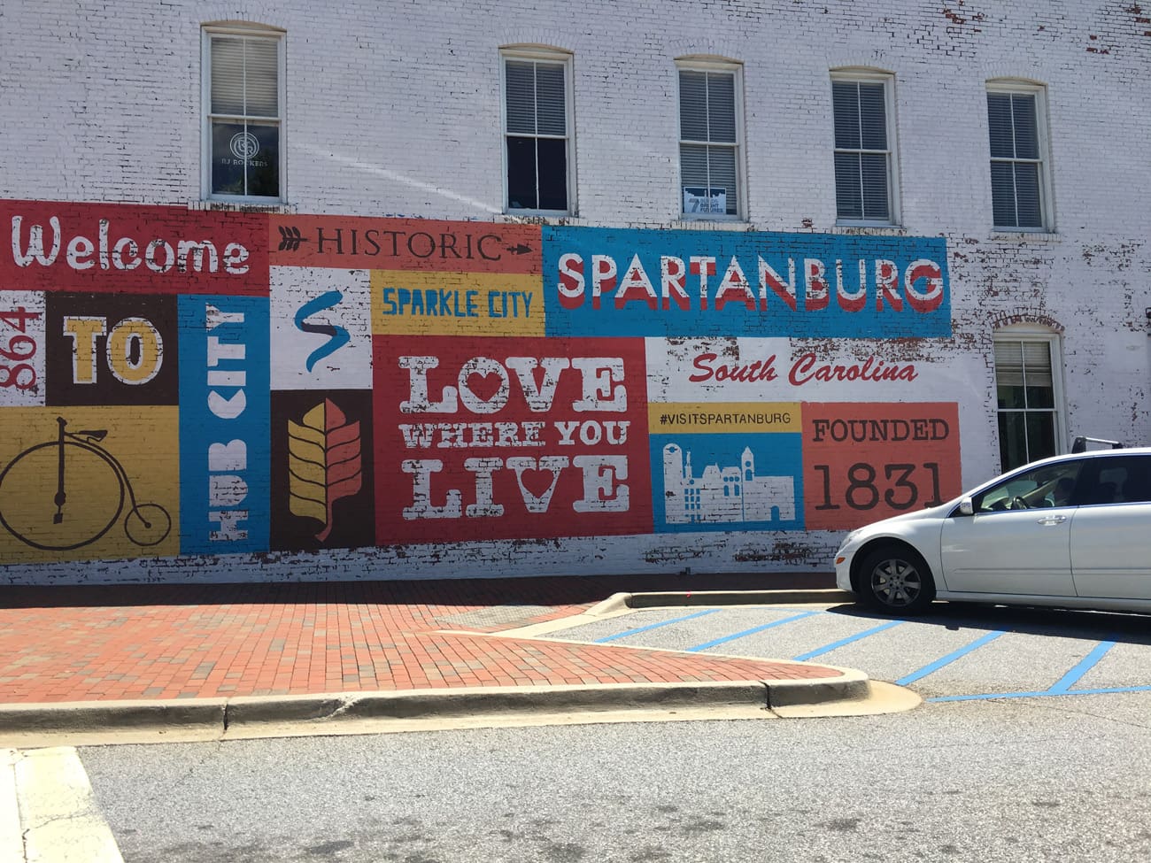 building in downtown Spartanburg SC with Welcome To Hub City and Sparkle City written on it